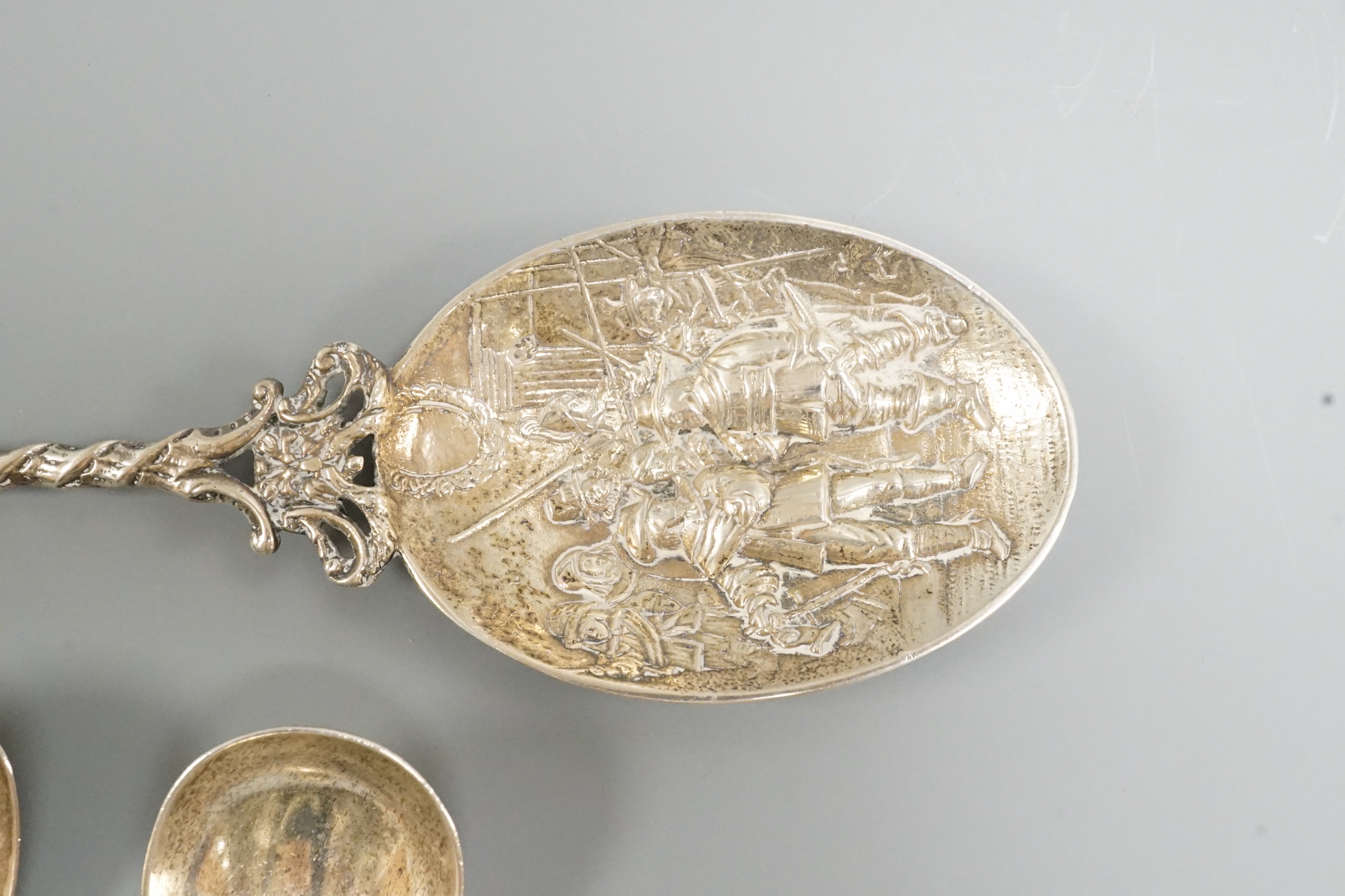 Two 19th century silver caddy spoons, including Birmingham, 1827, one later caddy spoon and an ornate Dutch white metal serving spoon.